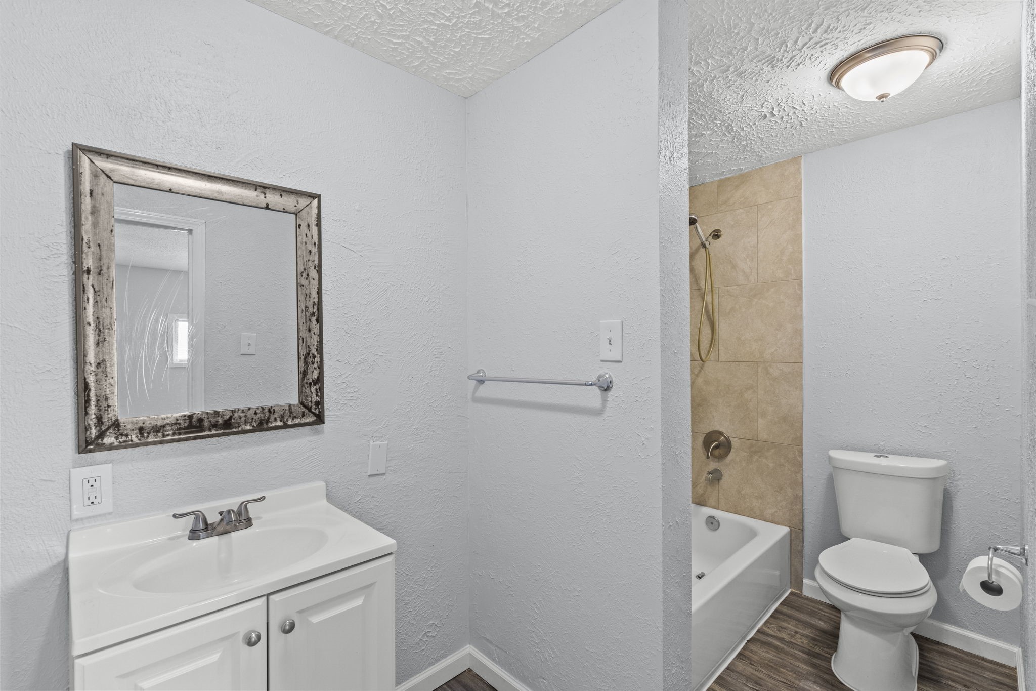 228 Orange Street La Marque, TX 77568 - Photo 8 of 21 a bathroom with a toilet sink vanity and mirror