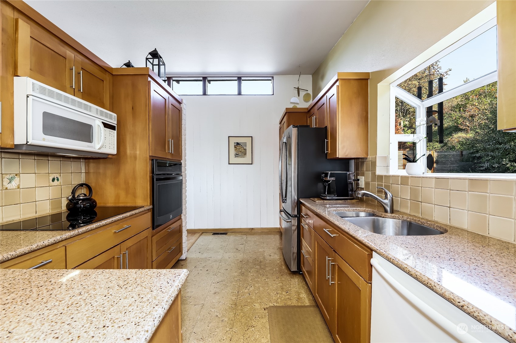 8724 Fauntlee Crest Southwest Seattle, WA 98136 - Photo 11 of 33 a kitchen with stainless steel appliances granite countertop a sink and a stove