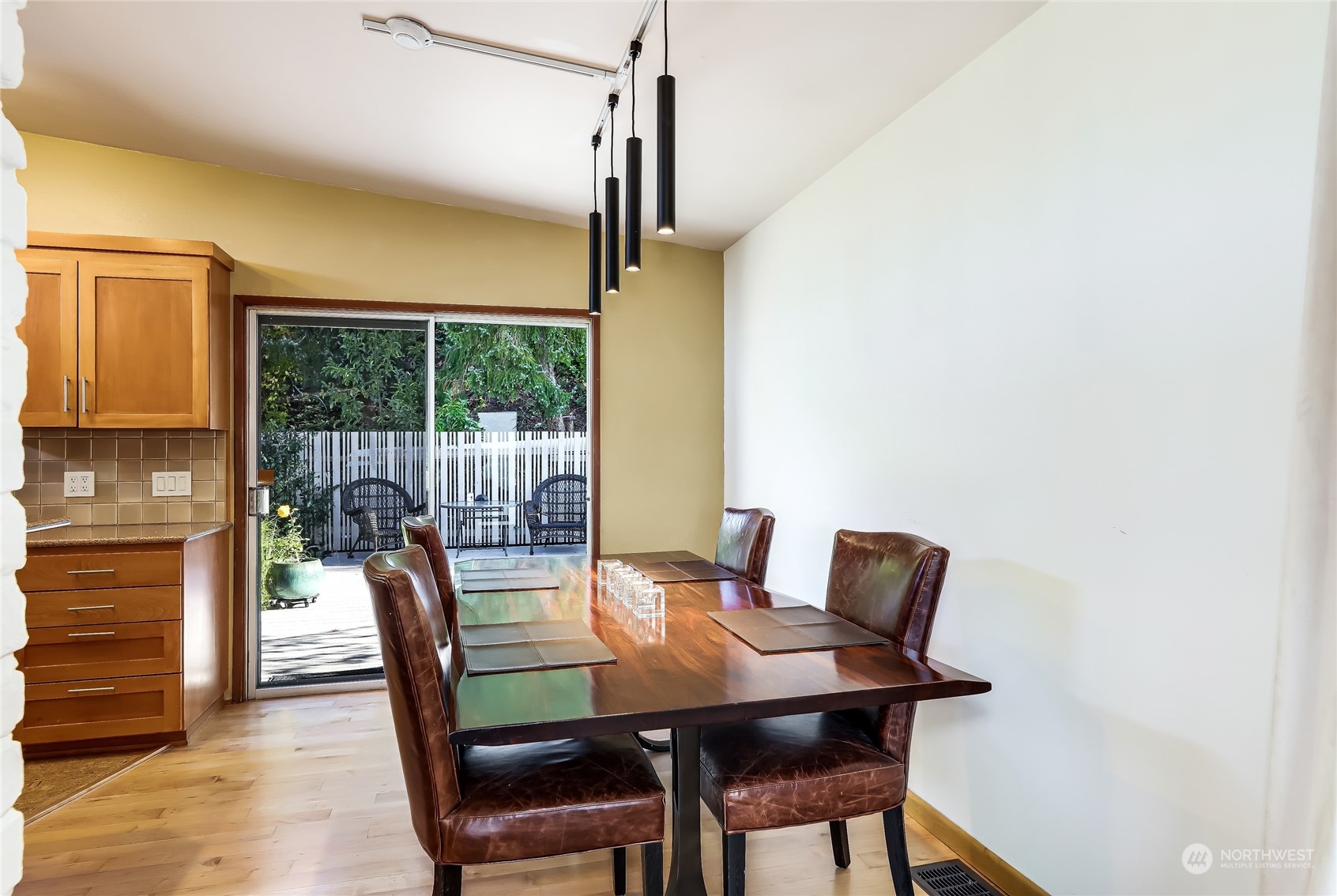 8724 Fauntlee Crest Southwest Seattle, WA 98136 - Photo 13 of 33 a view of a dining room with furniture window and wooden floor