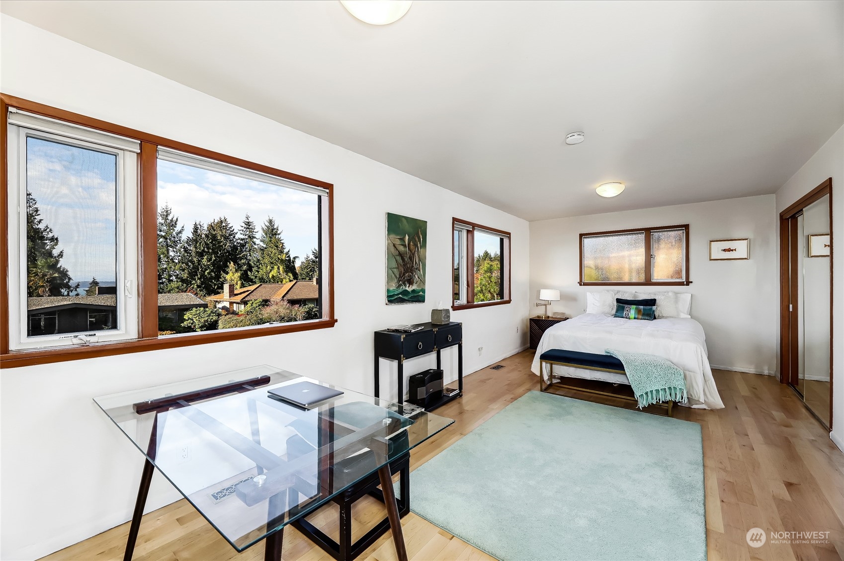 8724 Fauntlee Crest Southwest Seattle, WA 98136 - Photo 15 of 33 a bedroom with a bed and large window