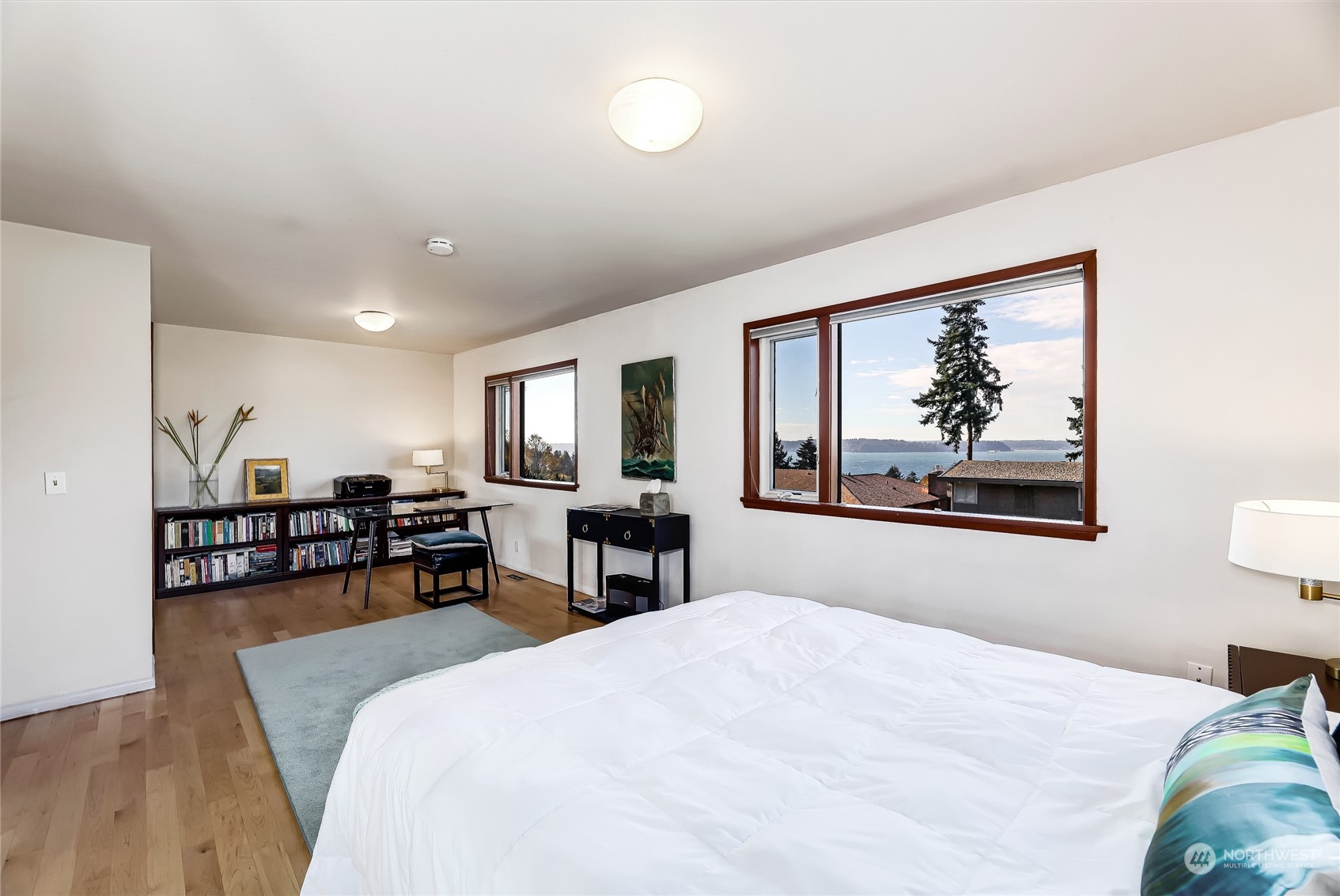 8724 Fauntlee Crest Southwest Seattle, WA 98136 - Photo 16 of 33 a bedroom with furniture and a bed
