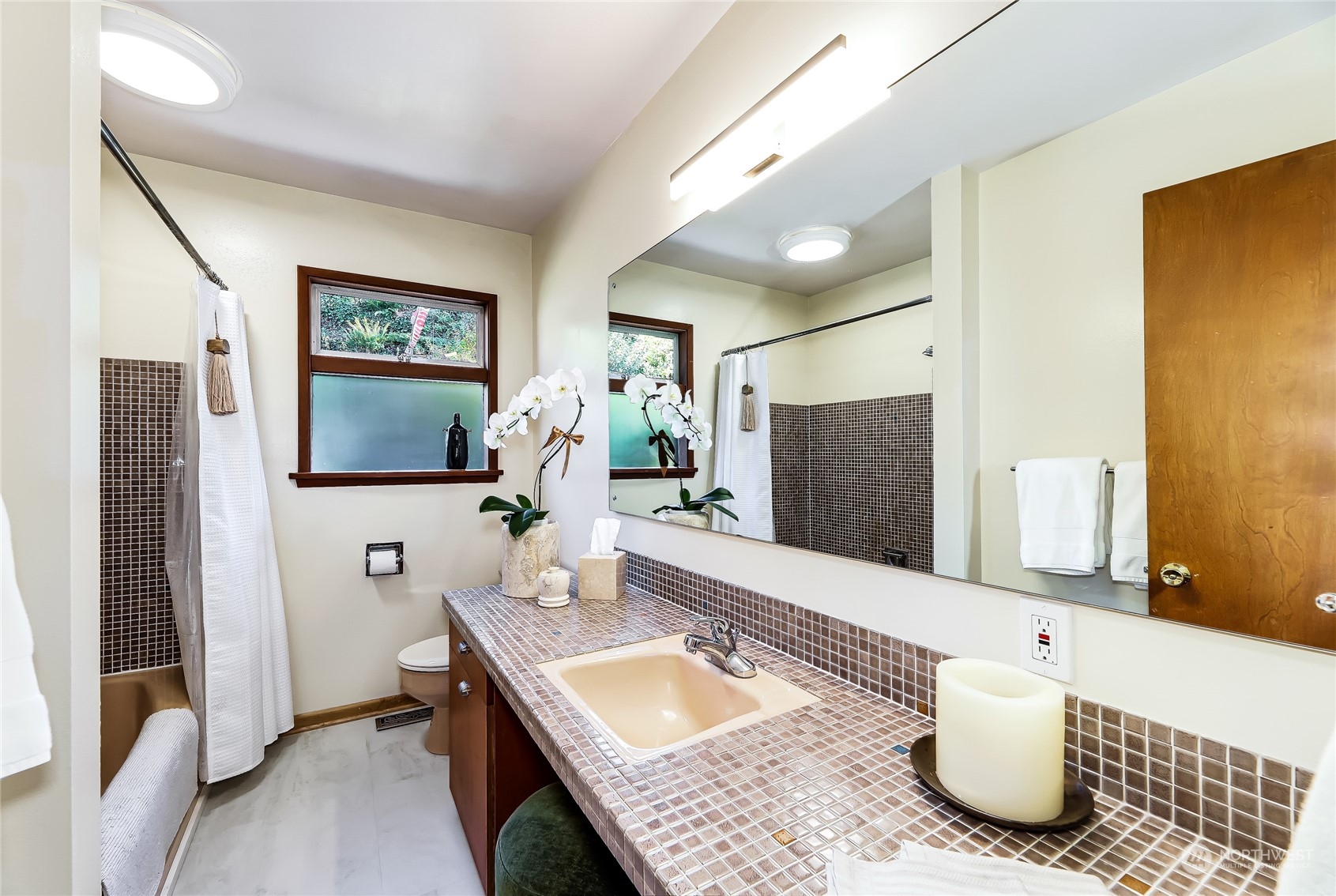 8724 Fauntlee Crest Southwest Seattle, WA 98136 - Photo 17 of 33 a bathroom with a granite countertop sink and a mirror