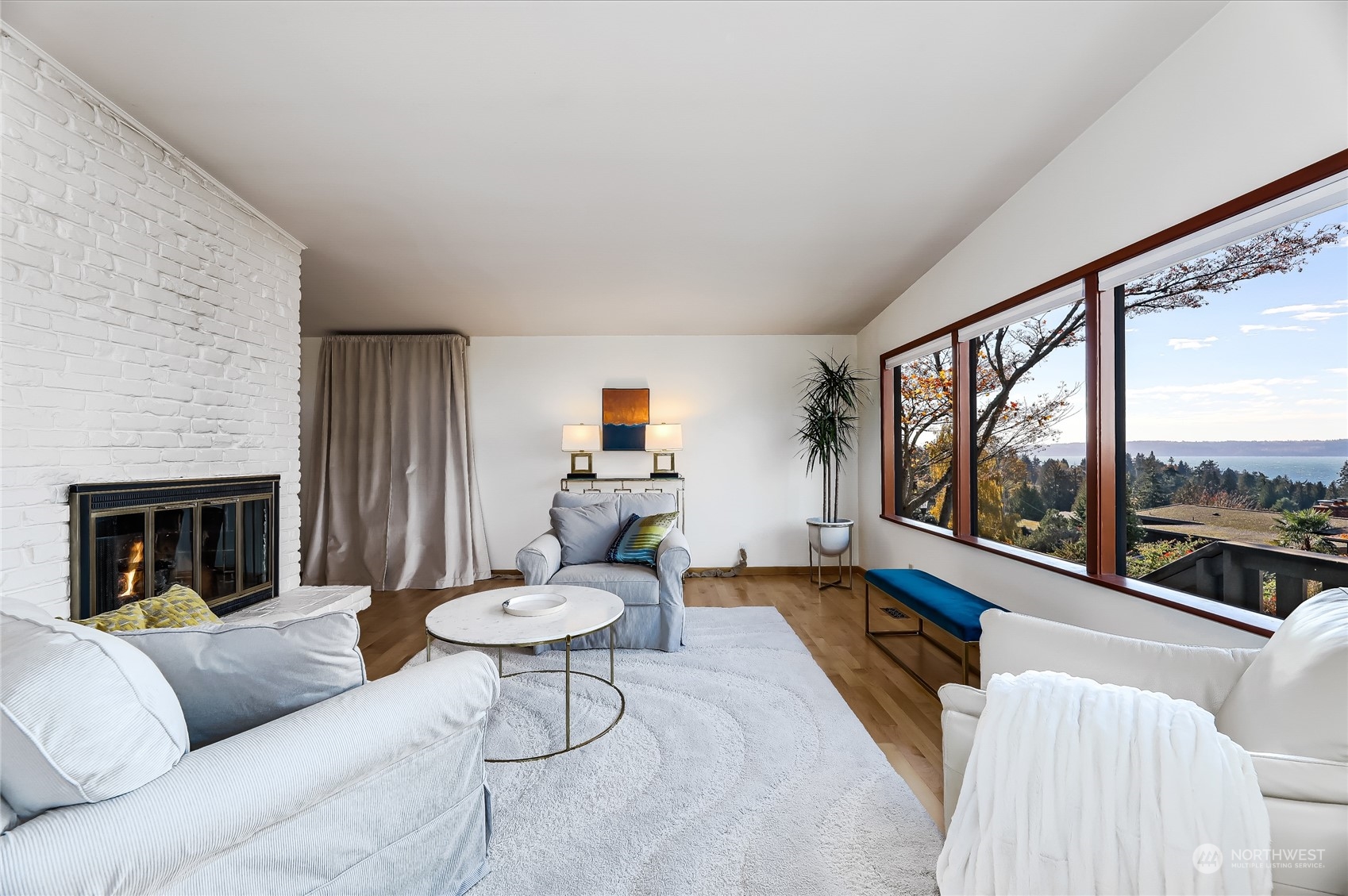 8724 Fauntlee Crest Southwest Seattle, WA 98136 - Photo 5 of 33 a living room with furniture and a large window