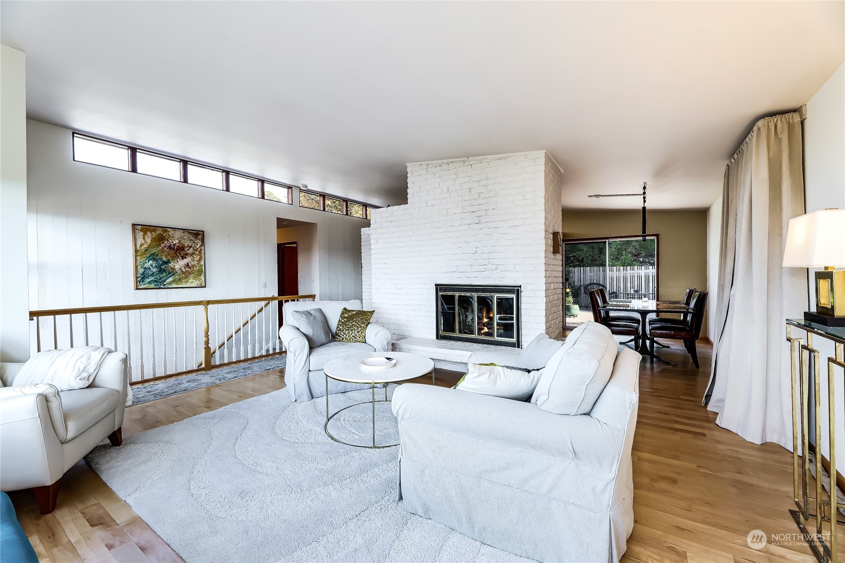 8724 Fauntlee Crest Southwest Seattle, WA 98136 - Photo 7 of 33 a living room with furniture a fireplace and a table