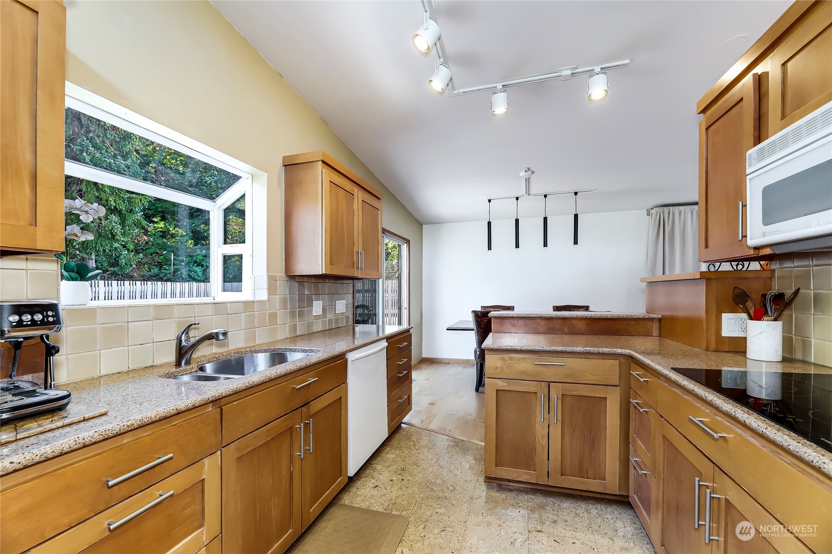 8724 Fauntlee Crest Southwest Seattle, WA 98136 - Photo 10 of 33 a kitchen with a sink stove and microwave