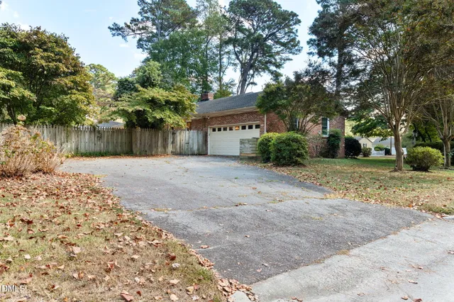 a view of a house with a tree in front of it