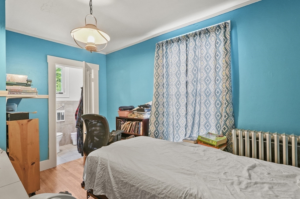 3 Newton Street Barre, MA 01005 - Photo 32 of 39 a bedroom with a bed and a chandelier