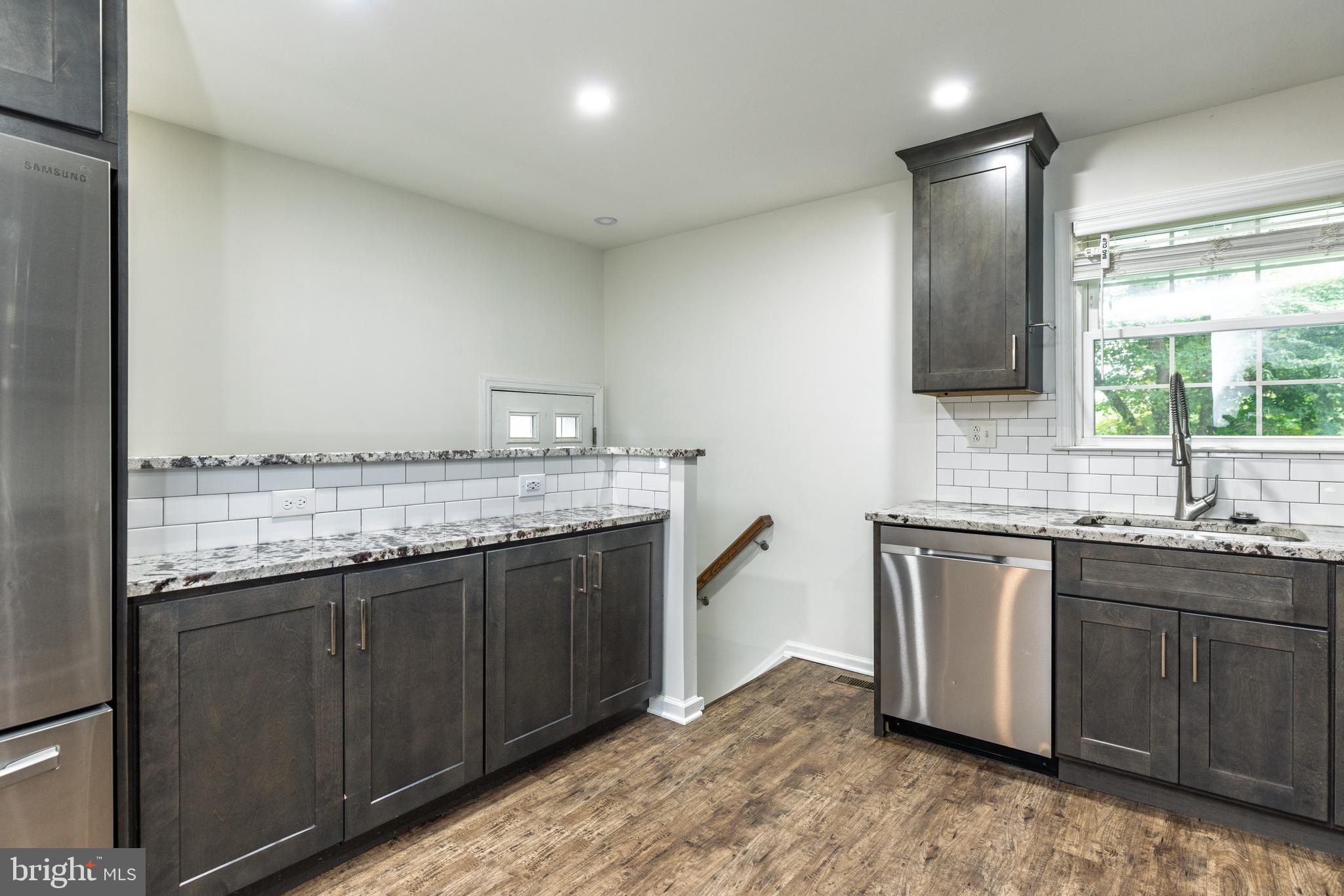 37 Millbrook Road Newark, DE 19713 - Photo 11 of 49 a bathroom with a granite countertop sink a mirror and a bathtub