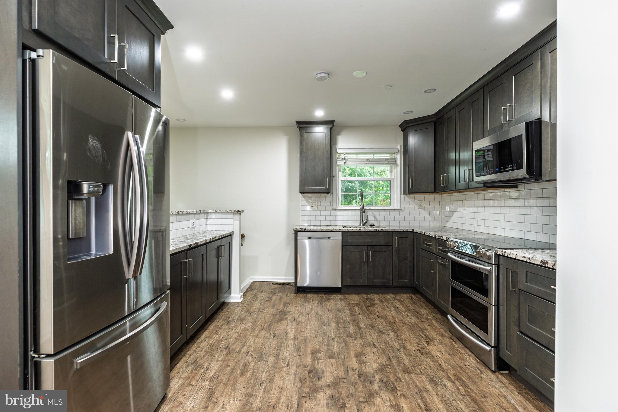 37 Millbrook Road Newark, DE 19713 - Photo 12 of 49 a kitchen with stainless steel appliances granite countertop a refrigerator a sink a stove top oven and a dishwasher