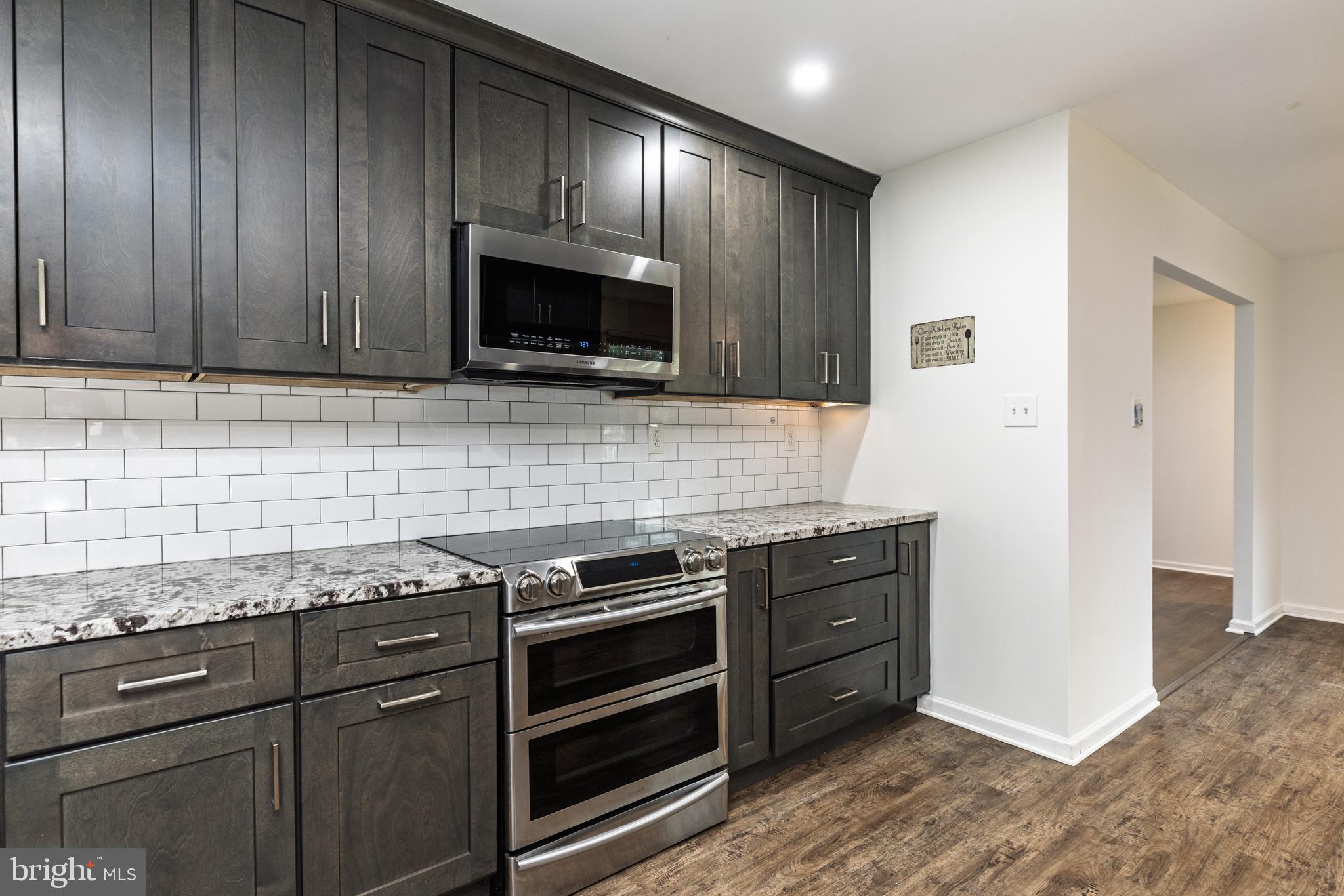 37 Millbrook Road Newark, DE 19713 - Photo 14 of 49 a kitchen with granite countertop wooden cabinets and stainless steel appliances