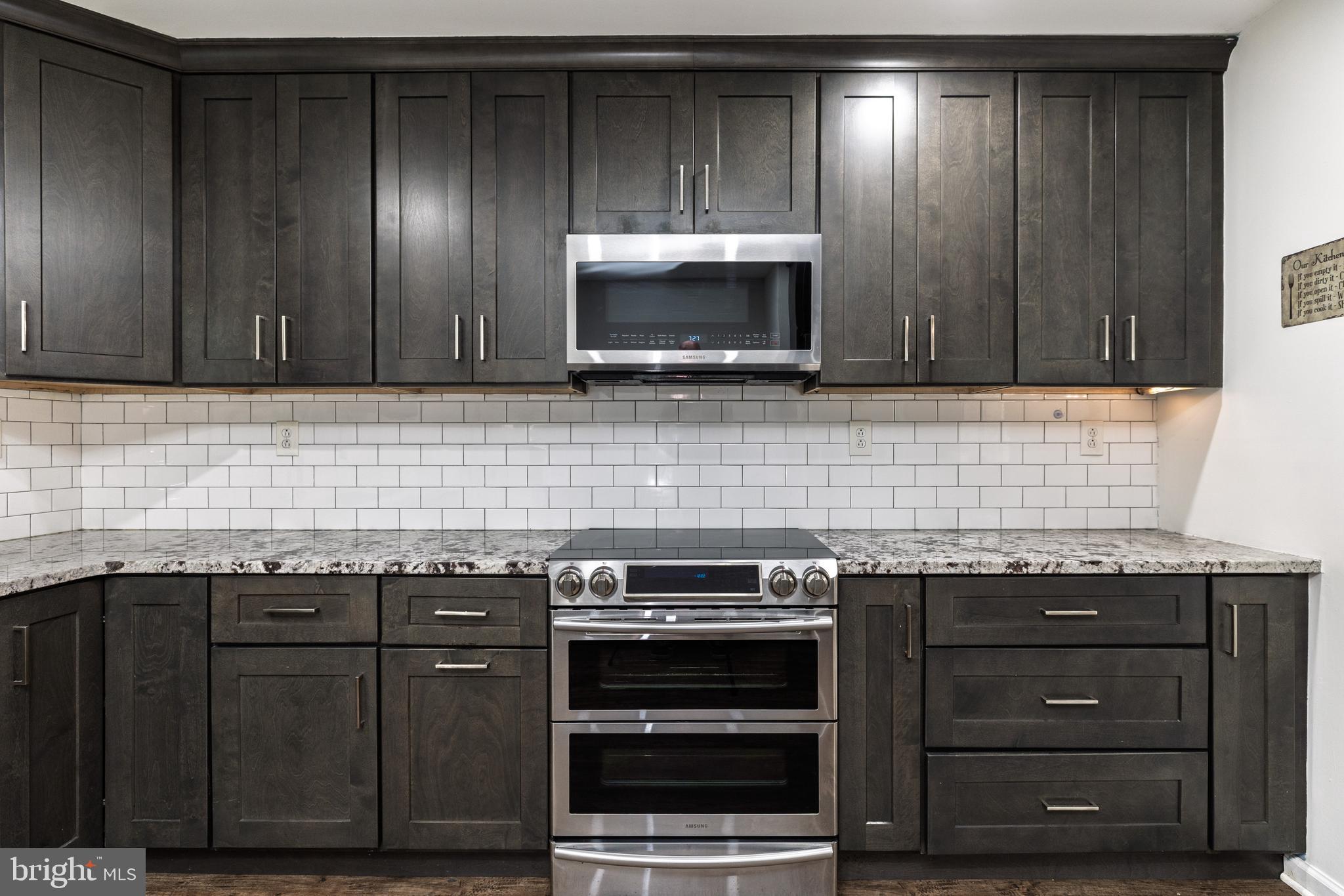 37 Millbrook Road Newark, DE 19713 - Photo 15 of 49 a kitchen with granite countertop wooden cabinets and stainless steel appliances