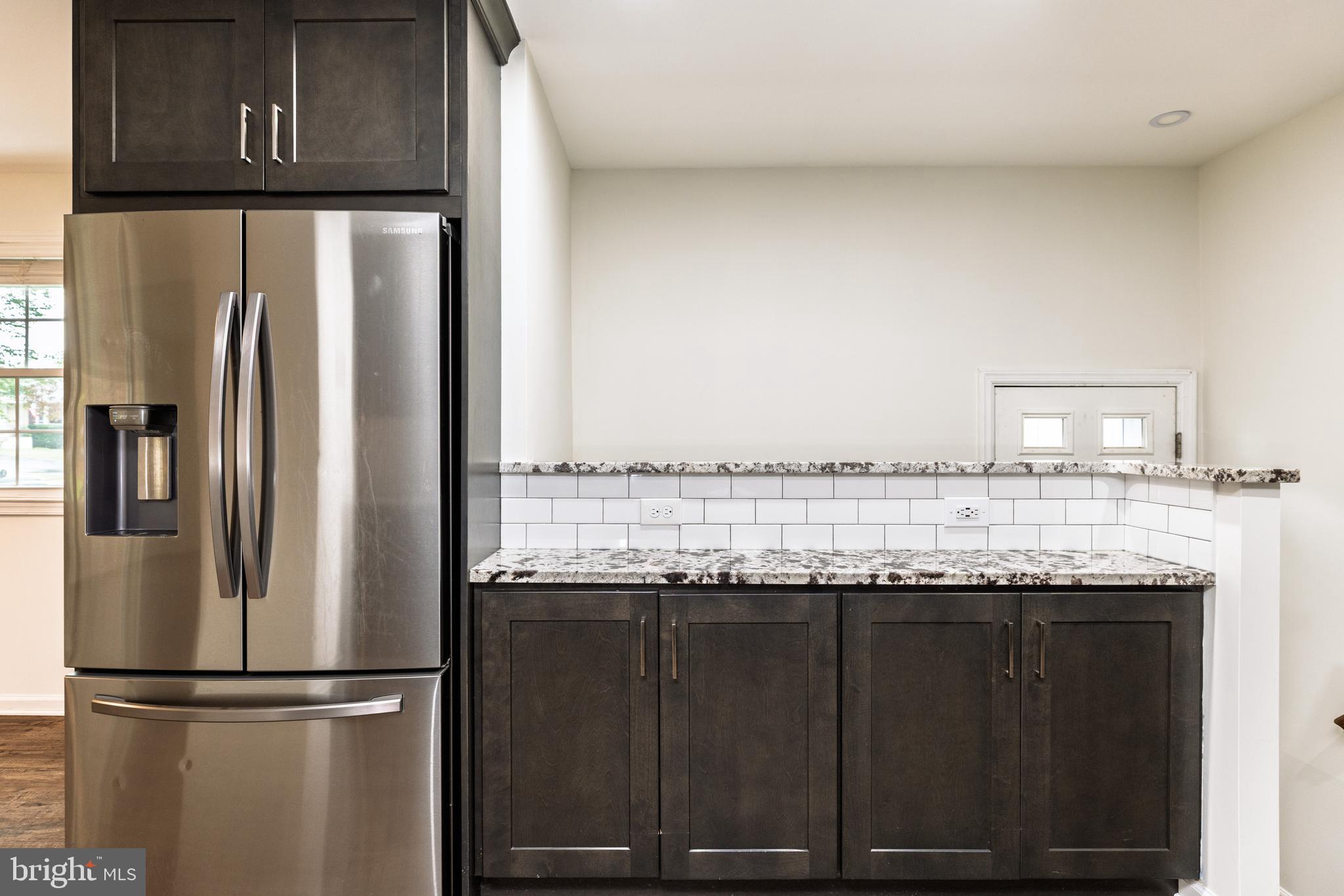 37 Millbrook Road Newark, DE 19713 - Photo 16 of 49 a kitchen with granite countertop a refrigerator and a sink