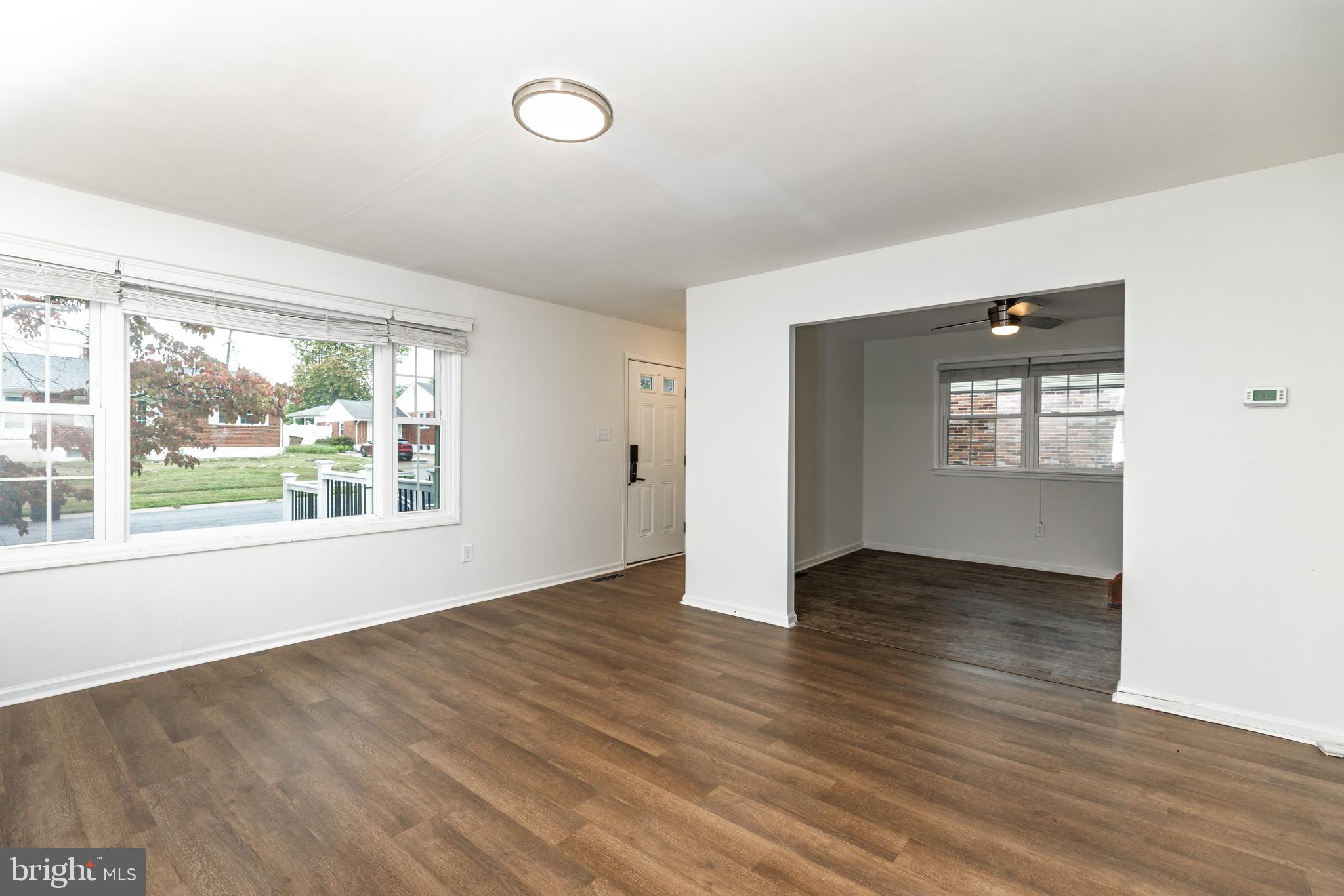37 Millbrook Road Newark, DE 19713 - Photo 5 of 49 an empty room with wooden floor and windows