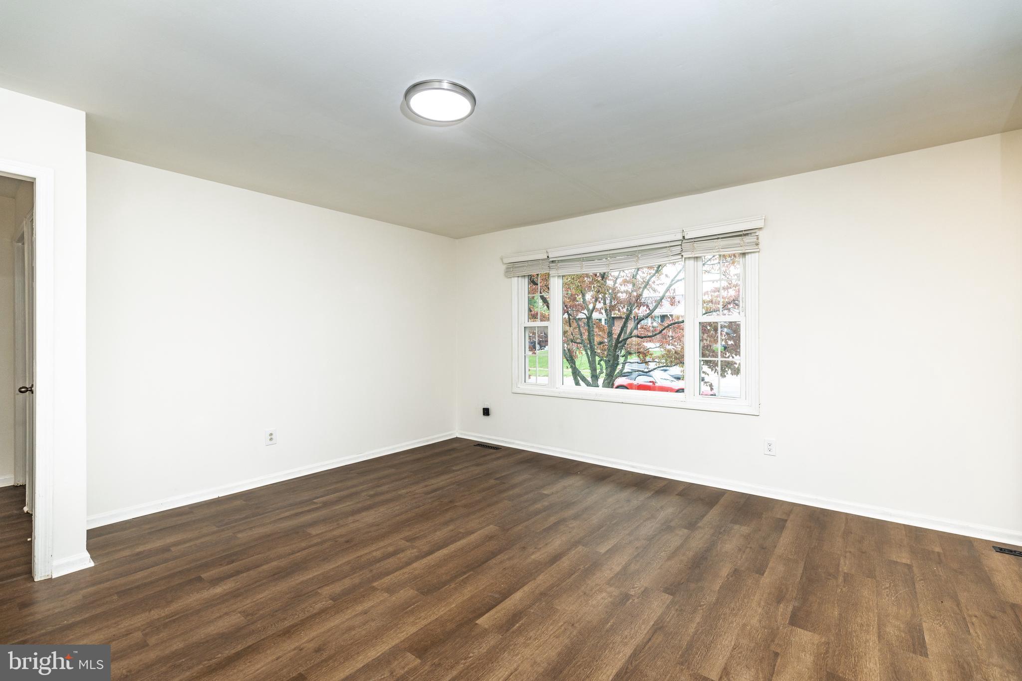 37 Millbrook Road Newark, DE 19713 - Photo 6 of 49 an empty room with wooden floor and windows