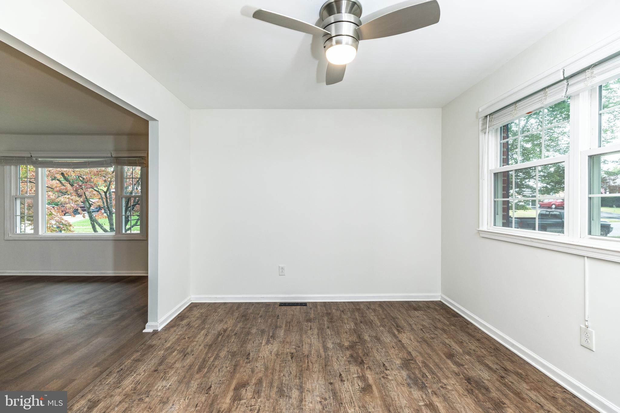 37 Millbrook Road Newark, DE 19713 - Photo 8 of 49 an empty room with wooden floor fan and windows