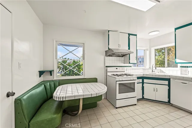 a kitchen with a stove a sink and a microwave