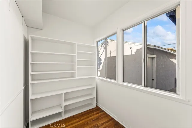 a view of walk in closet with empty racks