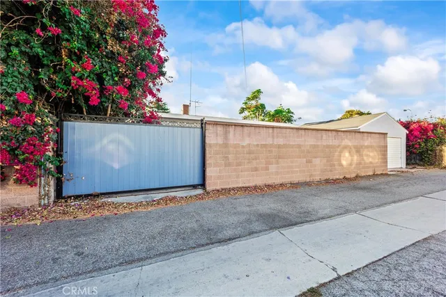 a view of a house with a backyard and a tree