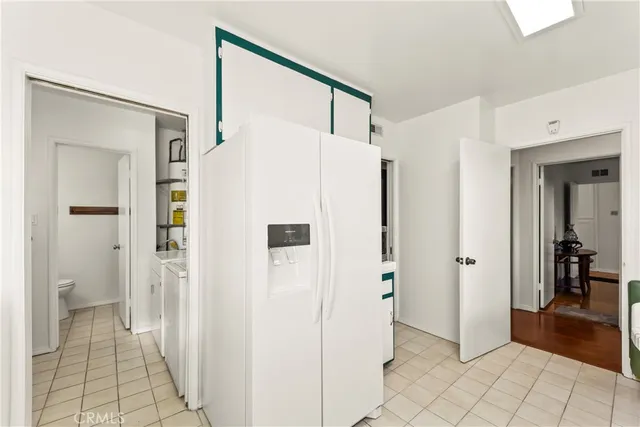 a white refrigerator freezer sitting in a kitchen