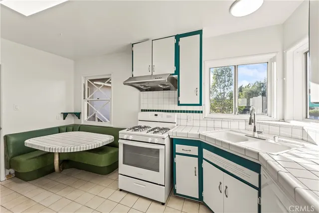 a kitchen with a sink stove and cabinets