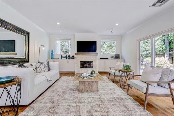 a living room with furniture a flat screen tv and a fireplace