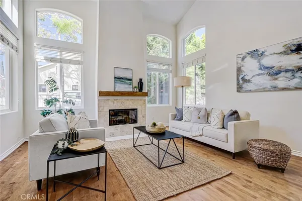a living room with furniture a fireplace and a table