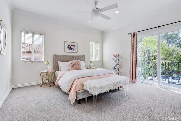 a spacious bedroom with a bed and a large window
