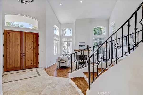 a view of staircase with furniture and a window