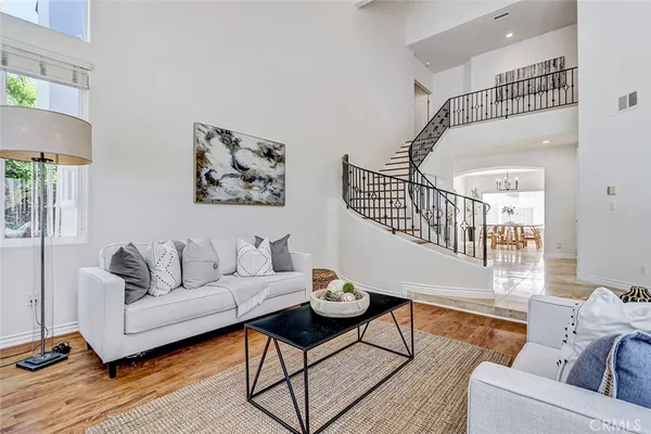 a living room with furniture and wooden floor
