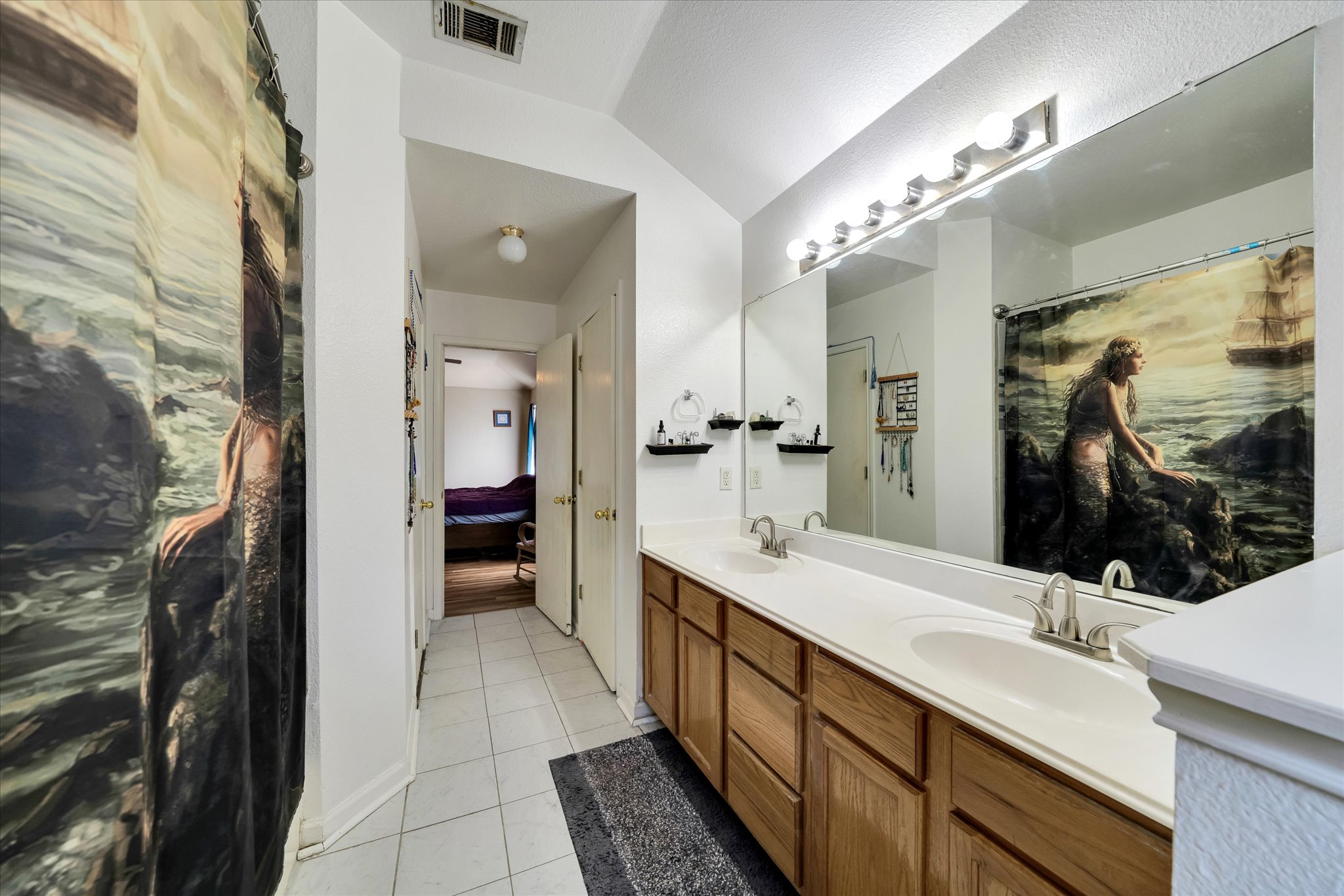 2601 Highcloud Drive Lockhart, TX 78644 - Photo 20 of 30 a bathroom with a double vanity sink and a mirror