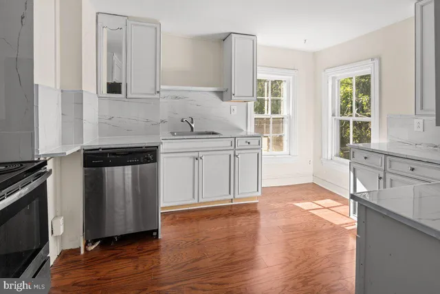 a kitchen with stainless steel appliances granite countertop a stove and a sink