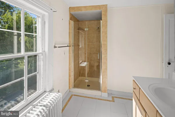 a bathroom with a tub and shower