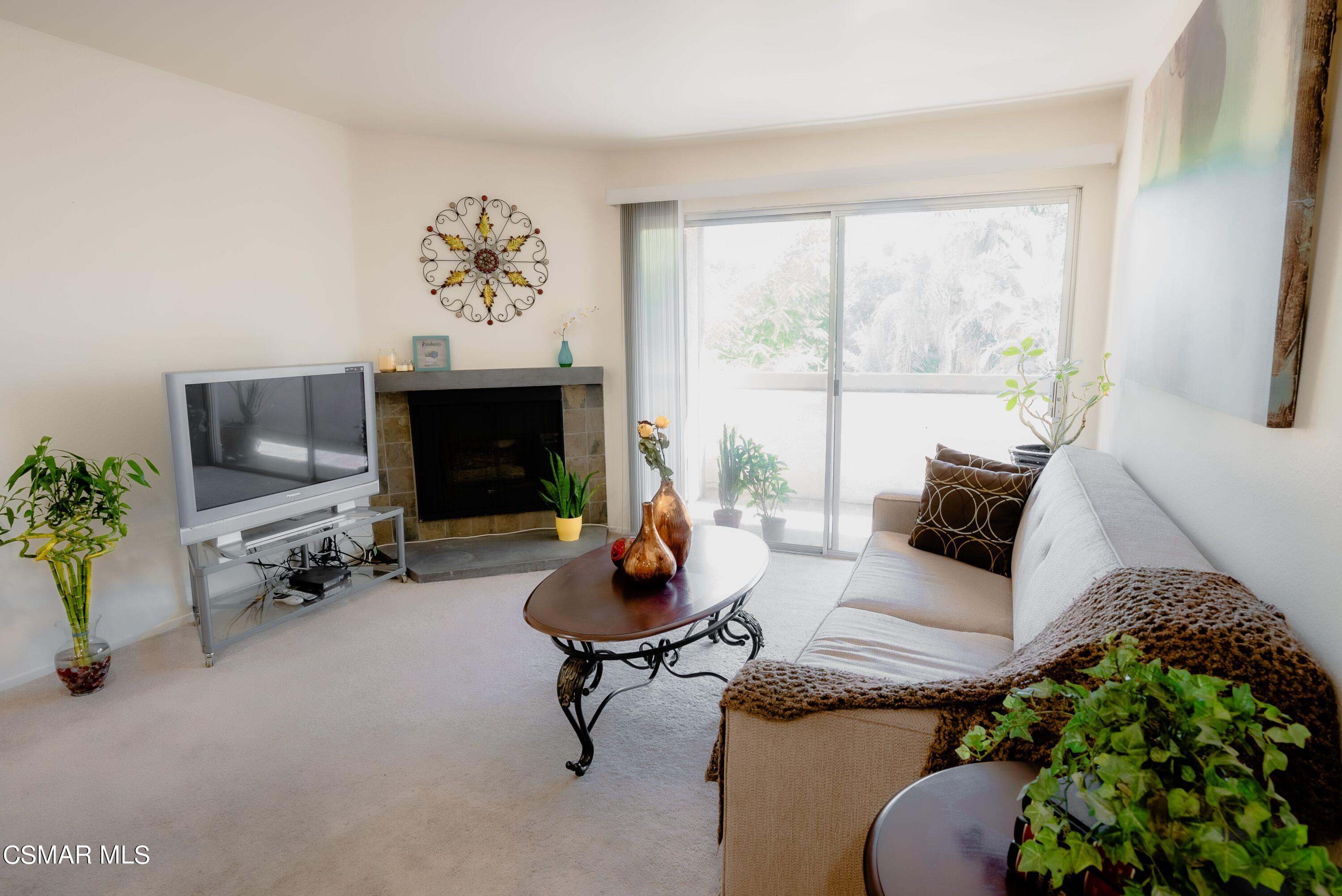20253 Keswick Street, Unit 233 Winnetka, CA 91306 - Photo 3 of 18 a living room with furniture and a fireplace