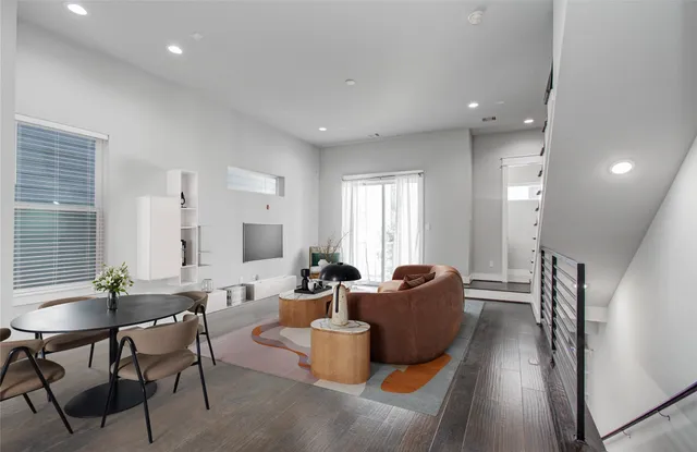 a living room with fireplace furniture and a wooden floor