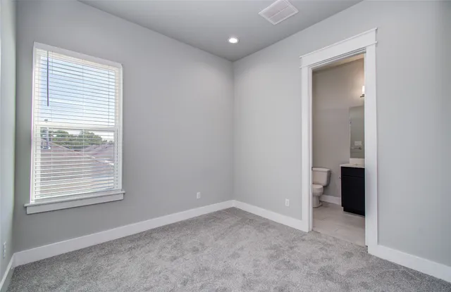 an empty room with closet and entryway