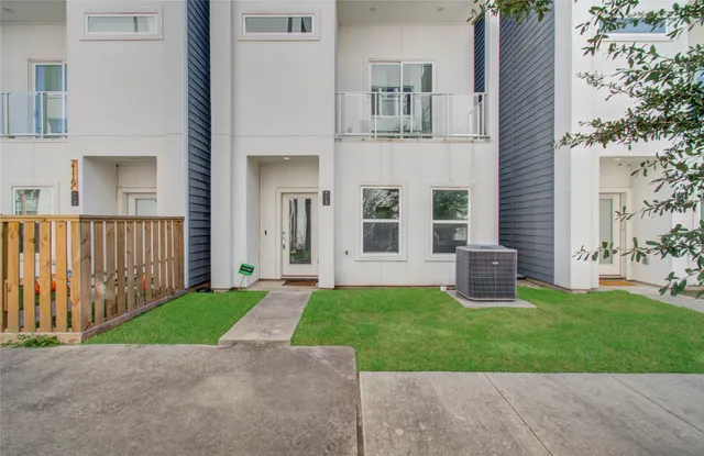 a view of a house with a yard and a patio