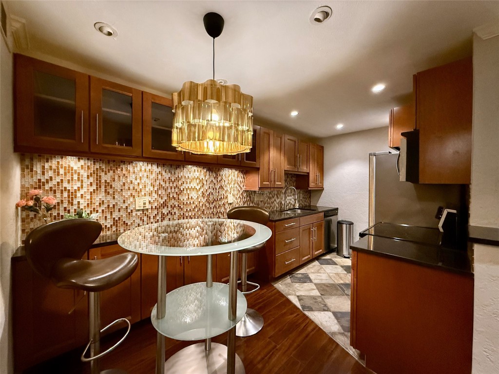 a kitchen with dining table and chairs