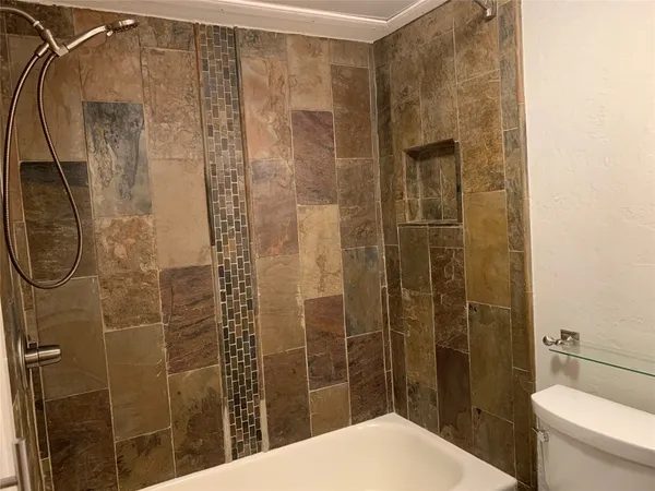 a bathroom with a toilet and shower