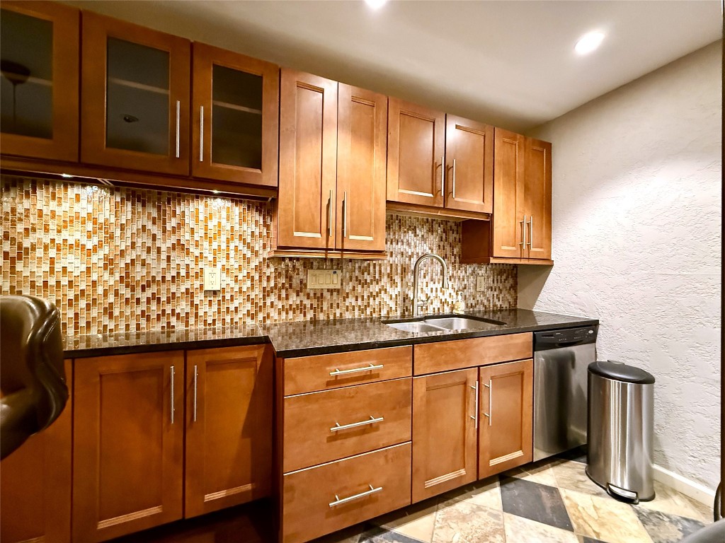 606 Marshall Street, Unit B13 Houston, TX 77006 - Photo 3 of 23 a kitchen with granite countertop wooden cabinets and sink