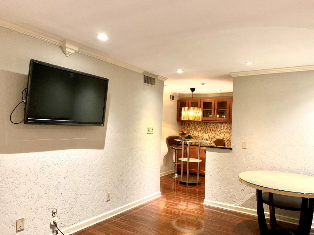 606 Marshall Street, Unit B13 Houston, TX 77006 - Photo 6 of 23 a living room with stainless steel appliances furniture and a flat screen tv