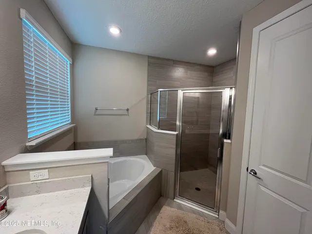 a bathroom with a shower a toilet and a sink