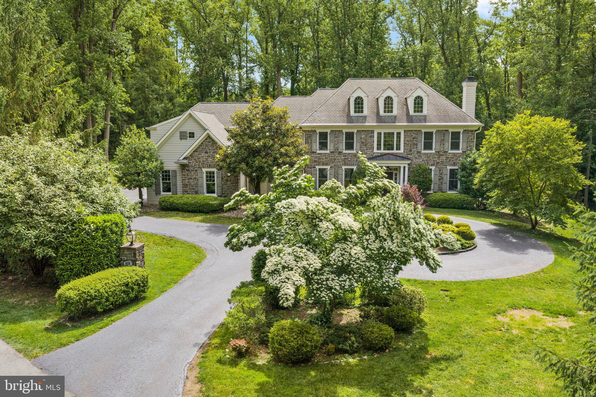 429 Church Road Devon, PA 19333 - Photo 2 of 55 Elegant stone home amid lush greenery.