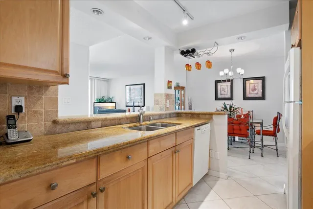 a spacious bathroom with a granite countertop sink and a mirror