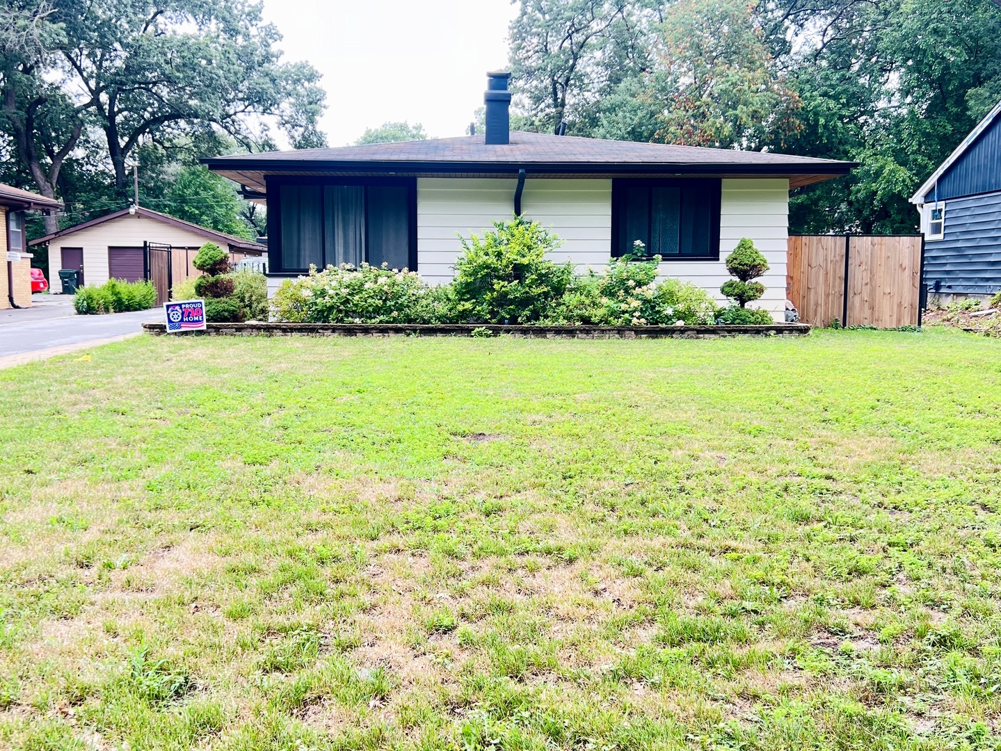 a front view of house with yard and trees
