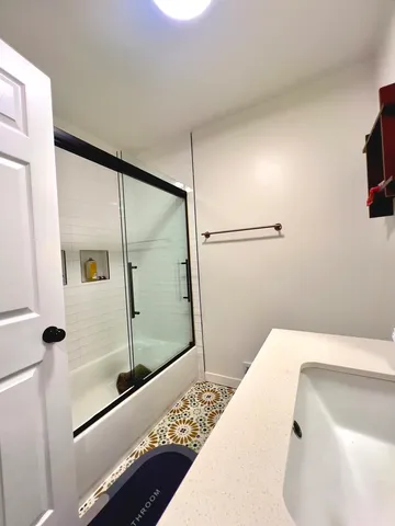 a bathroom with a bathtub and a shower