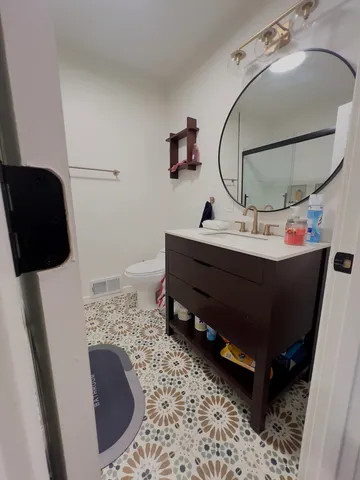 a bed room with a bed and a mirror