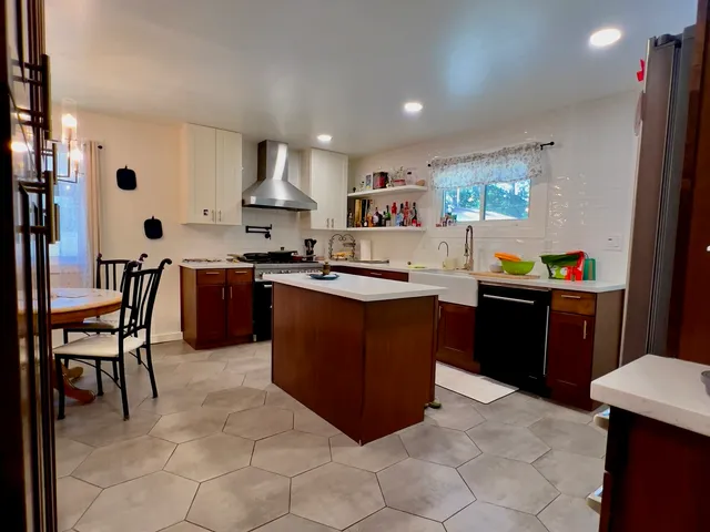 a kitchen with stainless steel appliances granite countertop a sink counter space and a window