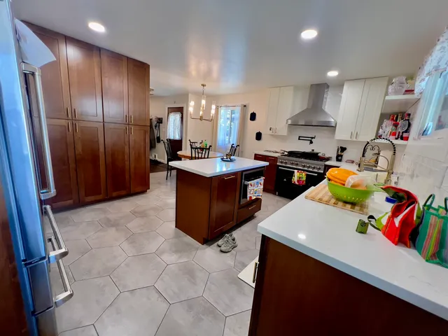 a kitchen with stainless steel appliances granite countertop a sink stove and refrigerator