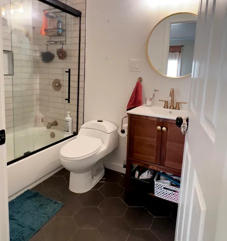 a bathroom with a sink toilet and shower
