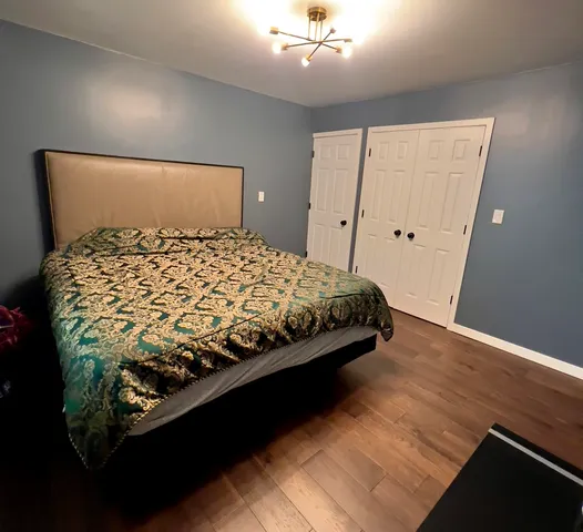 a bed sitting in a bedroom next to a window